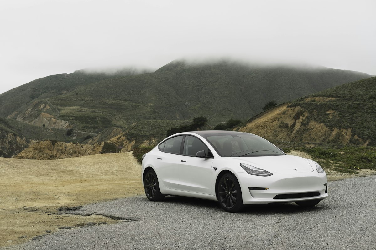 Electric vehicle on road (stock)